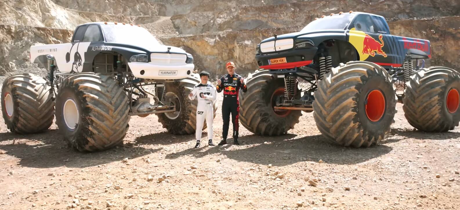 Formula 1 drivers Max Verstappen and Yuki Tsunoda stand in front of monster trucks