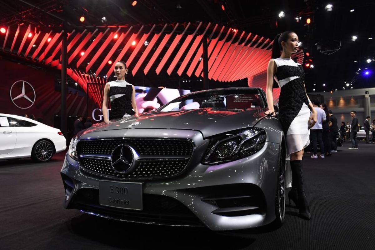 A silver Mercedes-Benz E300 on display at an auto show.