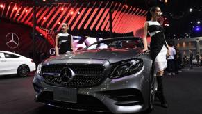 A silver Mercedes-Benz E300 on display at an auto show.
