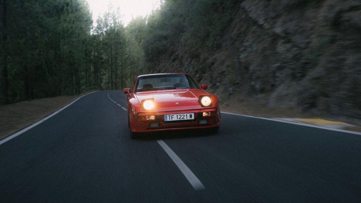 A Porsche 944 in red, on a backroad