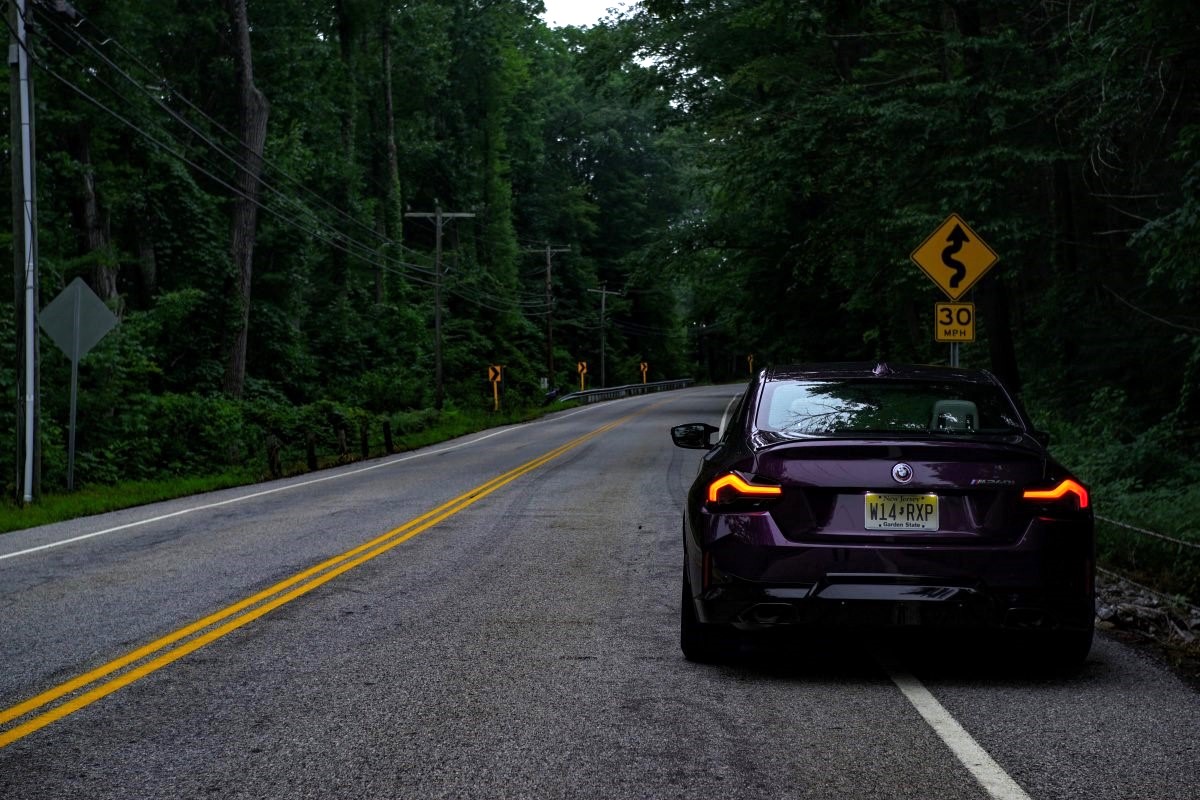 2023 BMW 2 Series in purple by a road sign