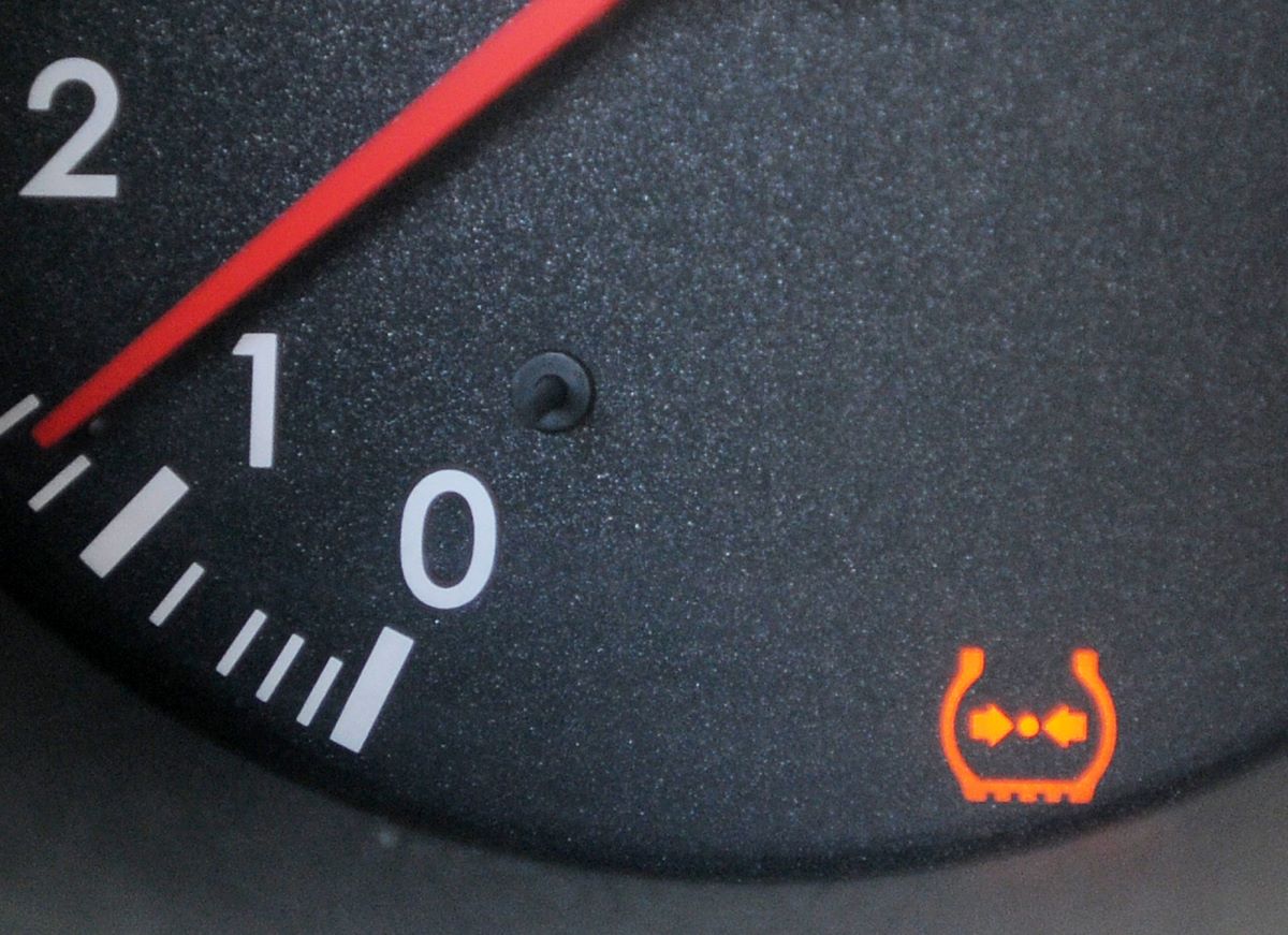 The TPMS (Tire Pressure Monitoring System) light on the dashboard of a Lexus model