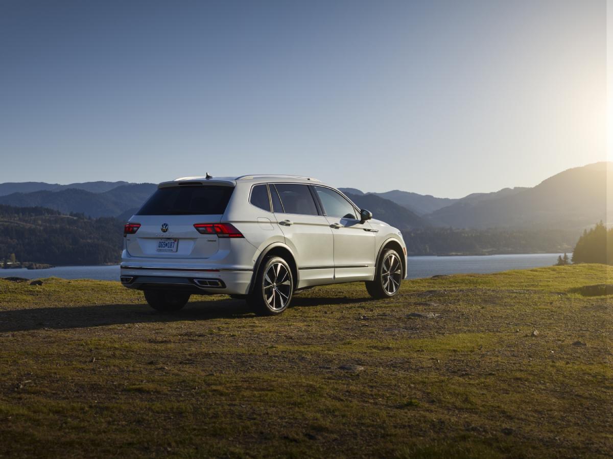A white Volkswagen Tiguan on display overlooking a lake.