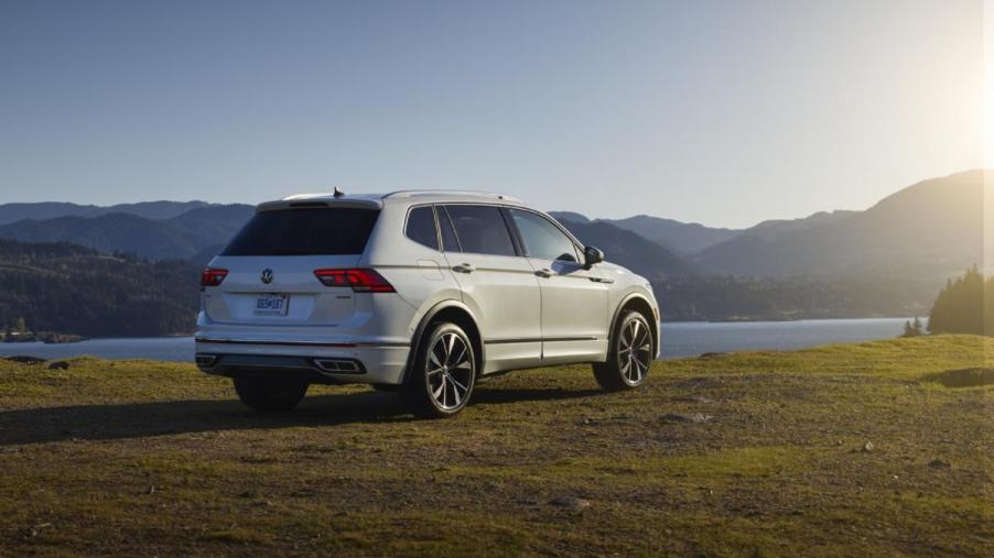 A white Volkswagen Tiguan on display overlooking a lake.
