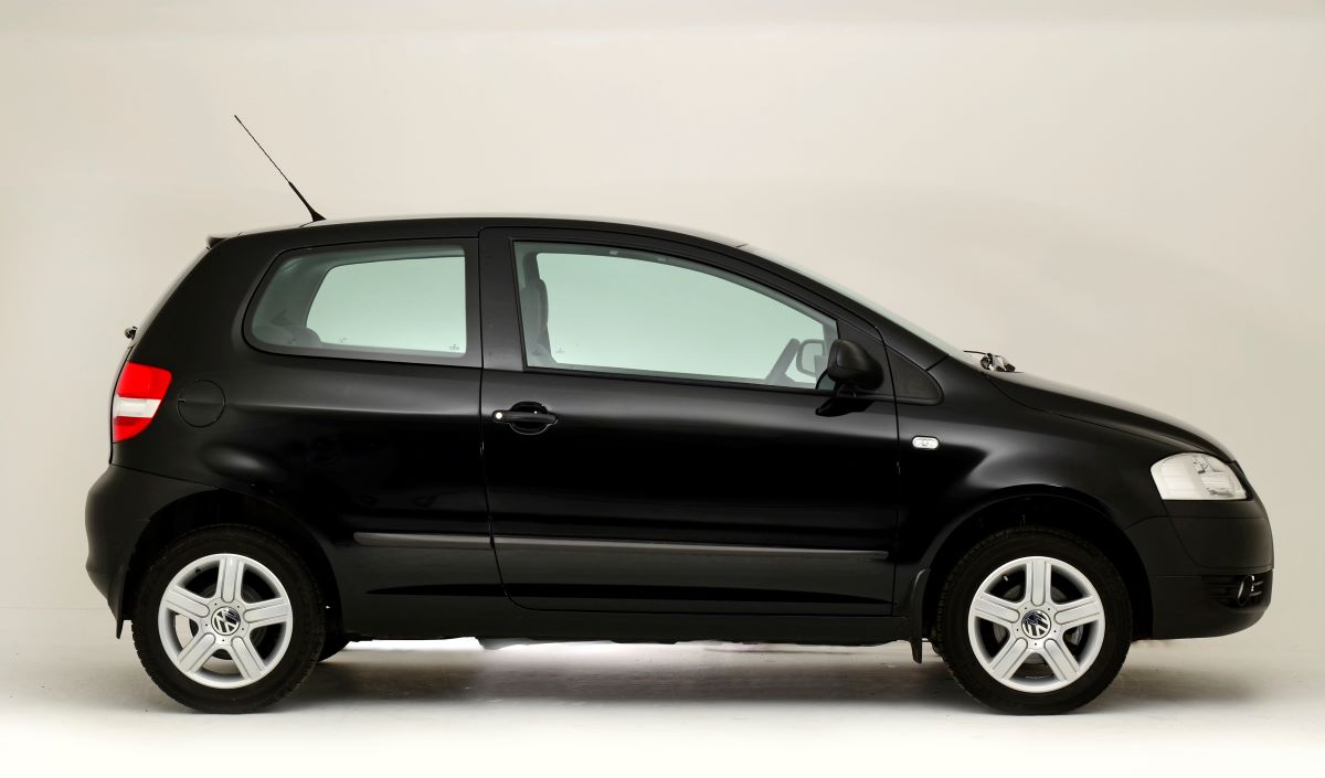A exterior side profile shot of a black 2008 Volkswagen Fox hatchback