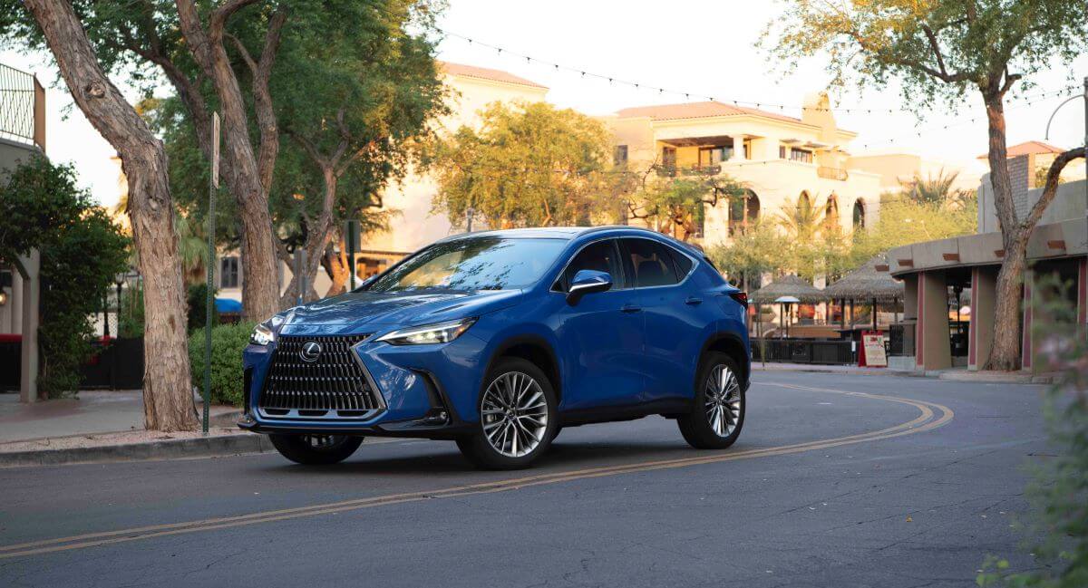 A 2024 Lexus NX 350h compact luxury hybrid SUV model parked on a twisting city road