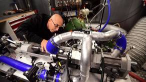 Aquarius Engines co-founder Shaul Yakobi with a single-piston car engine at the Campus Automobile Spa