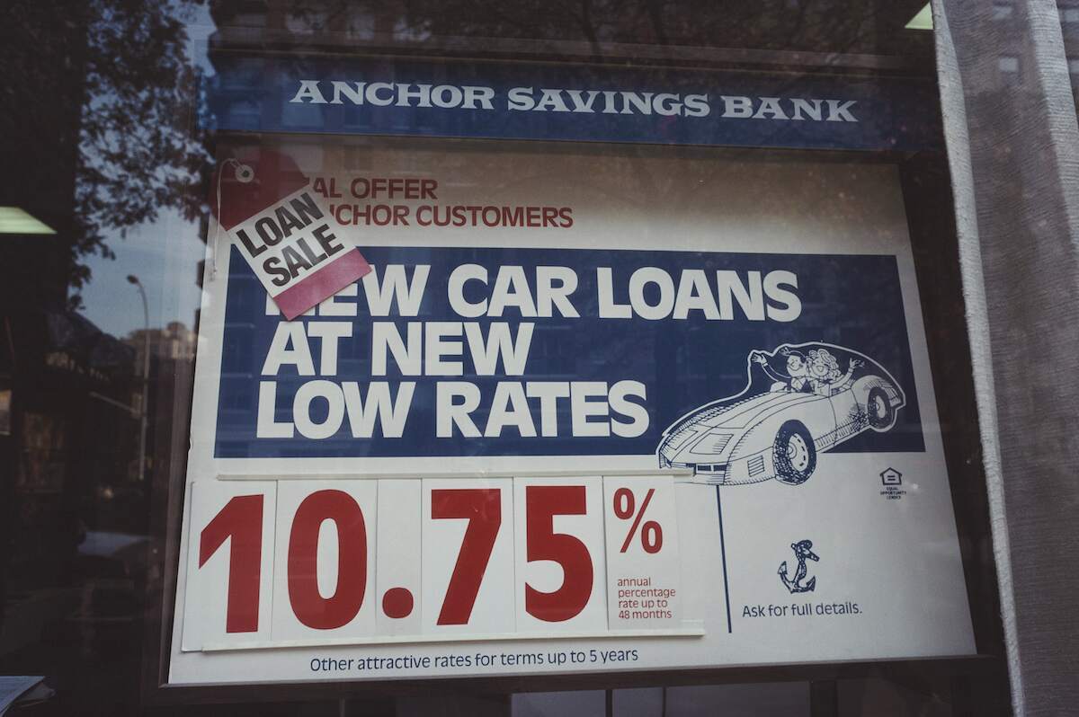 A sign advertising car loan rates in New York City in 1994