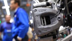 A front brake caliper on the assembly line for the production of the BMW i3 EV in Leipzig, Germany