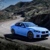 A BMW M2 subcompact executive car in Zandvoort Blue driving on a mountain highway