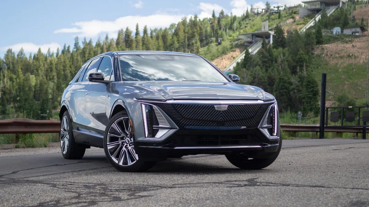 2024 Cadillac Lyriq EV SUV with green hills in background