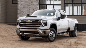 A 2024 Chevy Silverado 2500HD heavy-duty pickup truck model parked on dirt and sand on a building worksite