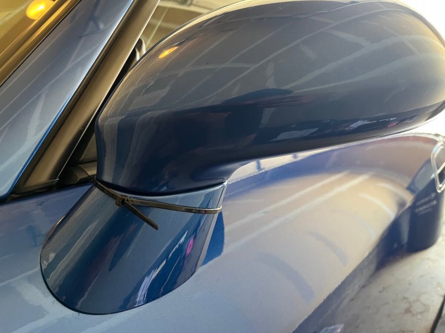 A zip tie on a car door mirror.