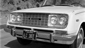 The Toyota logo in the grille of a 1966 Corona sedan.