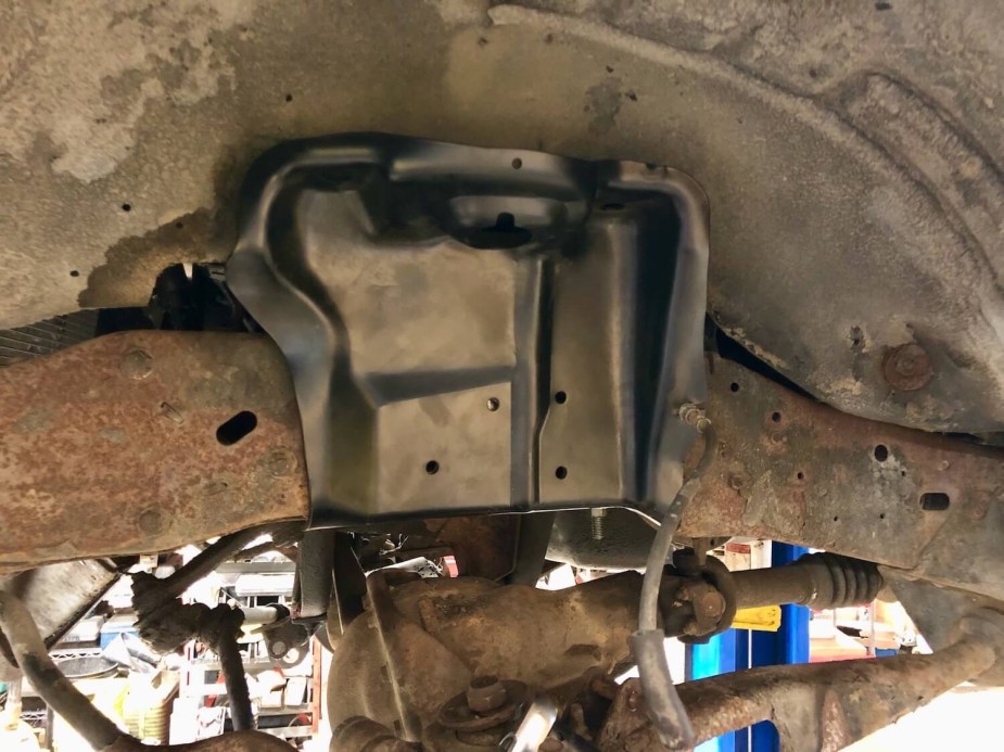 A suspension bracket attached to the frame of a Ford F-150 pickup truck.