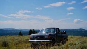 4WD 1988 Ford F-150 pickup truck parked on a mountaintop off-roading trail.