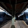 A pair of Acela trains parked side-by-side at a public transit station