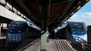 A pair of Acela trains parked side-by-side at a public transit station