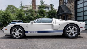 Side profile view of 2005 Ford GT in white with blue racing stripes after full restoration
