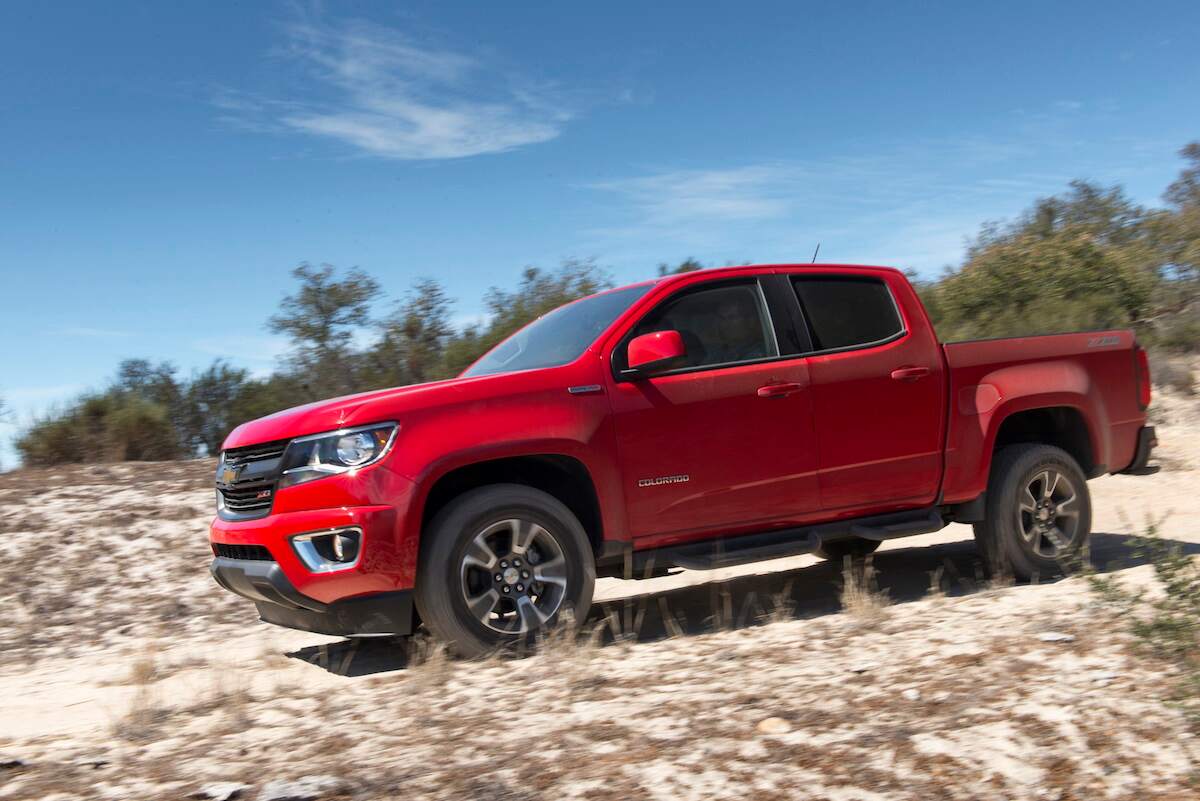 A red 2018 Chevy Colorado Diesel on a sand dune