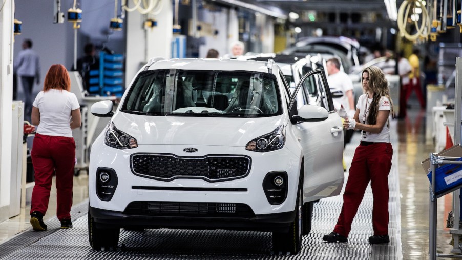The 2018 Kia Sportage in white being assembled at the factory. The 2018 Sportage is a premier used compact SUV.