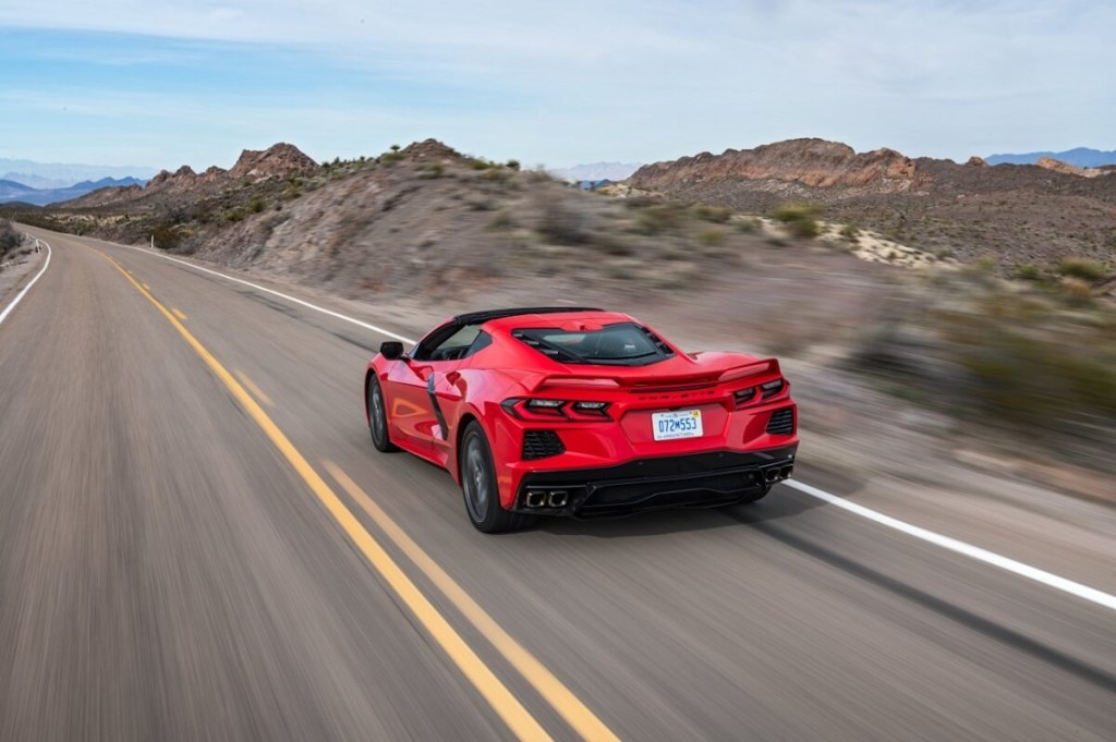 A red 2023 Chevrolet Corvette C8 Stingray blasts down a desert road.