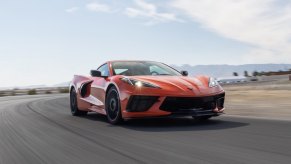 A 2023 Chevrolet Corvette C8 Stingray shows off its handling by taking a corner on a track.