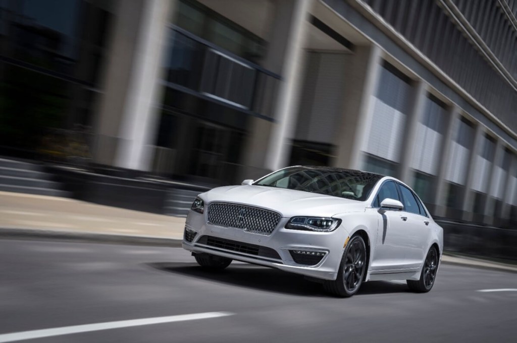 A white 2020 Lincoln MKZ drives down city streets.