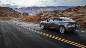 A grey 2020 Mazda6 sedan driving in the mountains