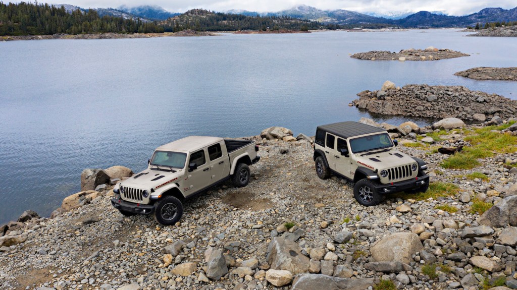 Special edition Jeep SUV and truck in unique Gobi beige color, a lake visible in the background.