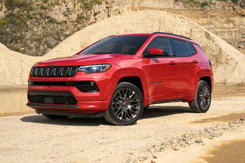 Red 2023 Jeep Compass SUV on dirt