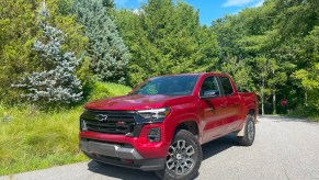 The 2023 Chevy Colorado parked near evergreen trees