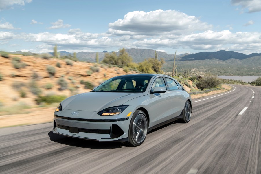 Car and Driver's "EV of the Year" – the 2023 Hyundai Ioniq 6 – in gray driving on a desert road.