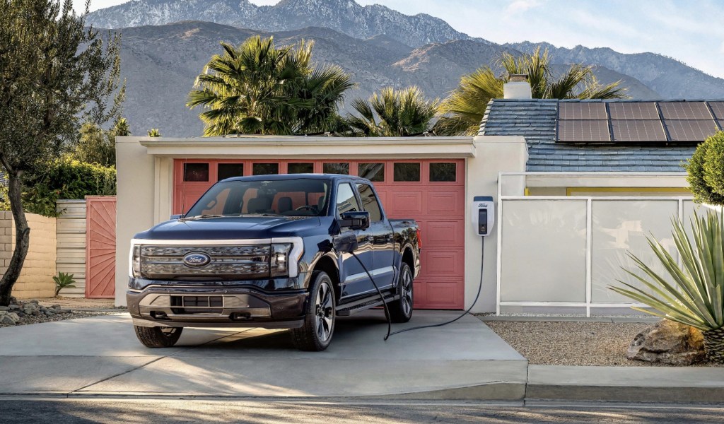 The 2023 Ford F-150 Lightning charging at a home