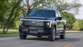 The 2023 Ford F-150 Lightning driving down the road
