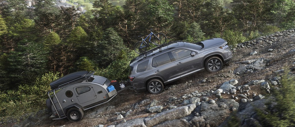 The 2023 Honda Pilot pulling a trailer while off-roading