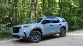 The 2023 Honda Pilot TrailSport off-roading in the woods