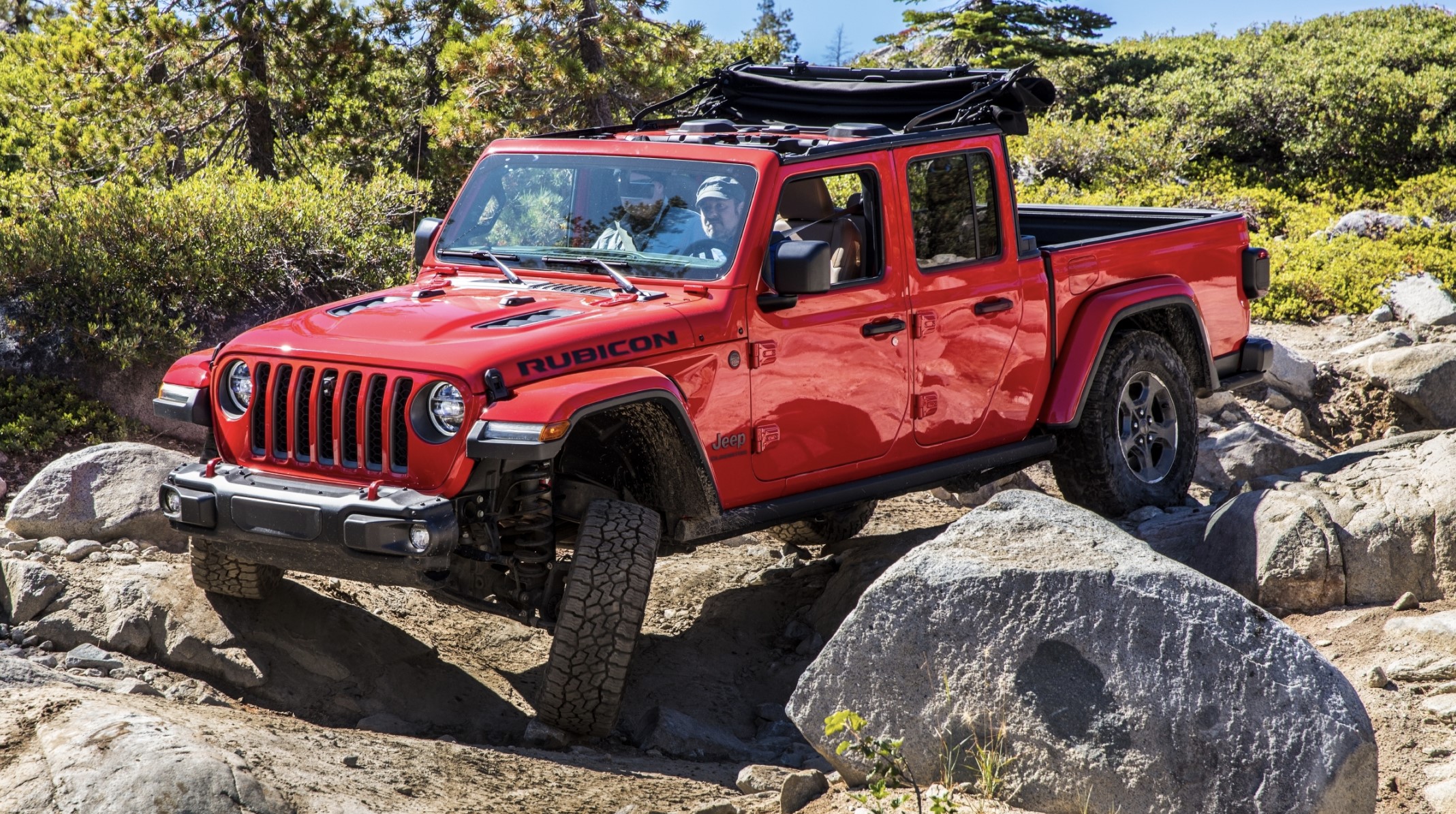 The 2023 Jeep Gladiator off-roading over rocks