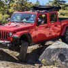 The 2023 Jeep Gladiator off-roading over rocks
