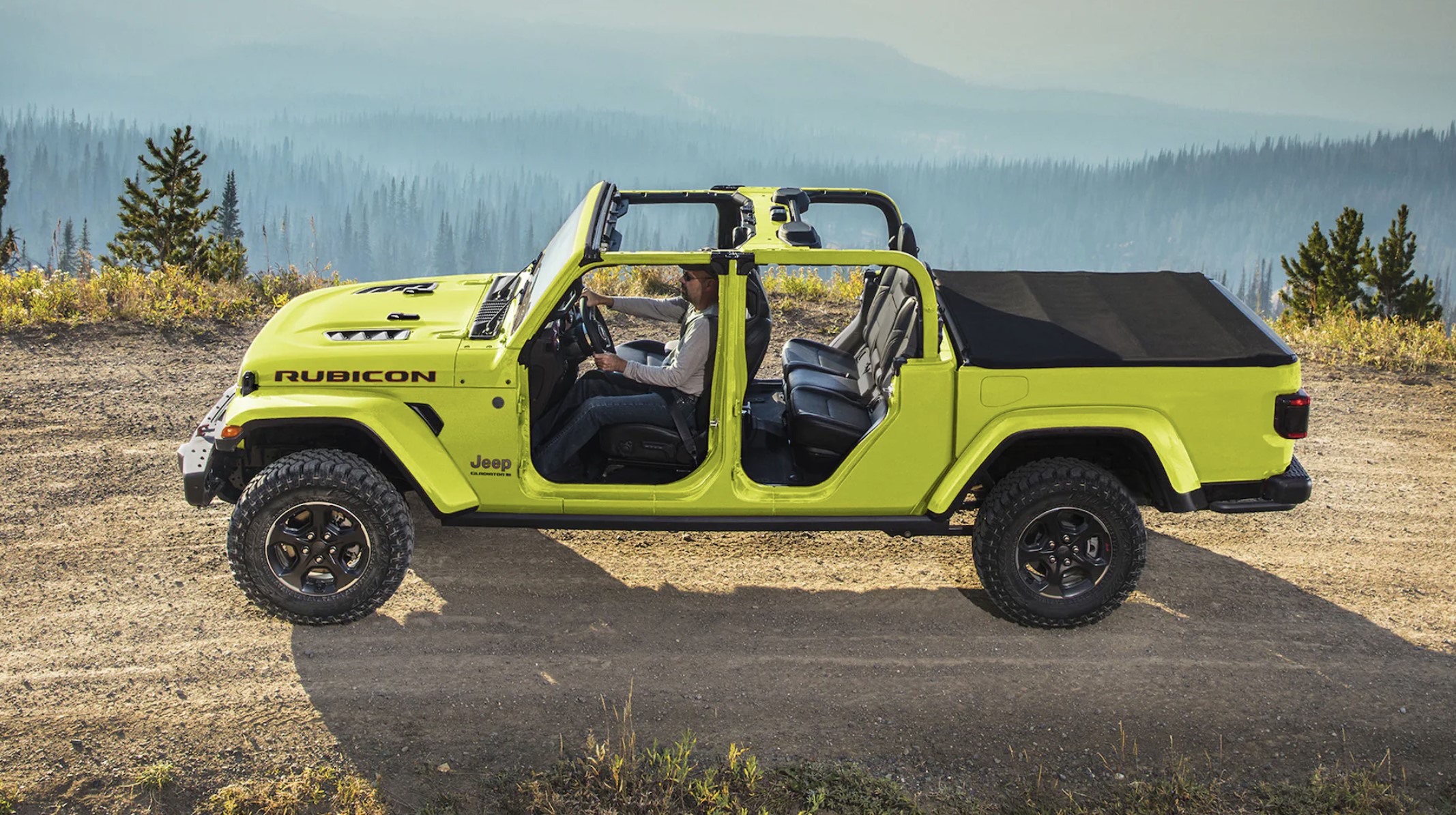 The 2023 Jeep Gladiator Rubicon off-roading on a dirt path