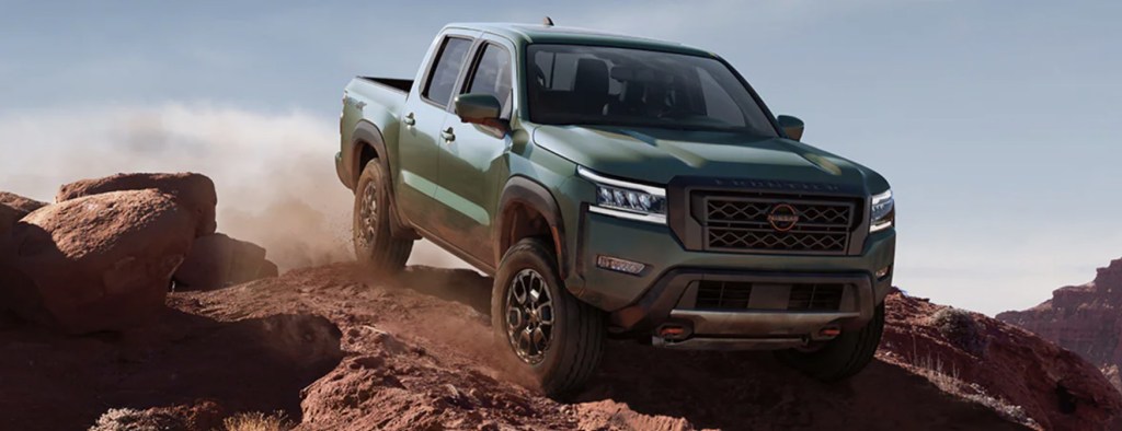 The 2023 Nissan Frontier off-roading over rocks 