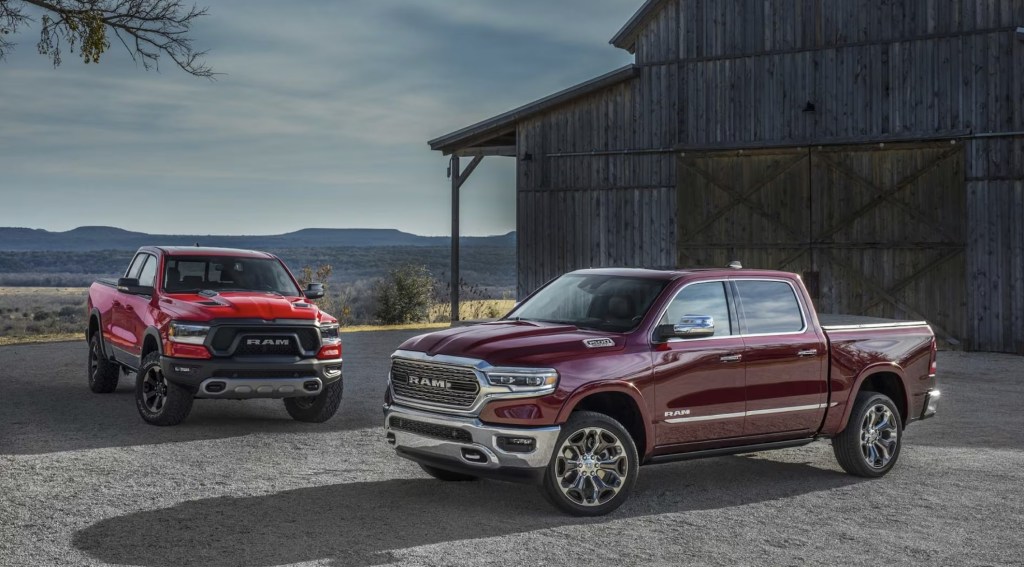Two 2023 Ram 1500 models parked near a barn 