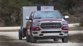 Red Ram 1500 pickup truck towing a trailer.