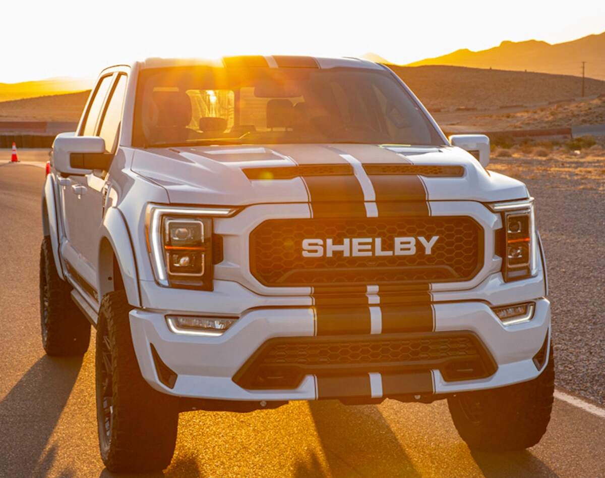 A white 2023 Shelby F-150 truck with racing stripes