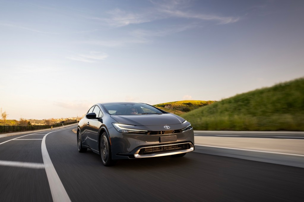 A gray 2023 Toyota Prius Prime shows off its small car proportions and side profile.