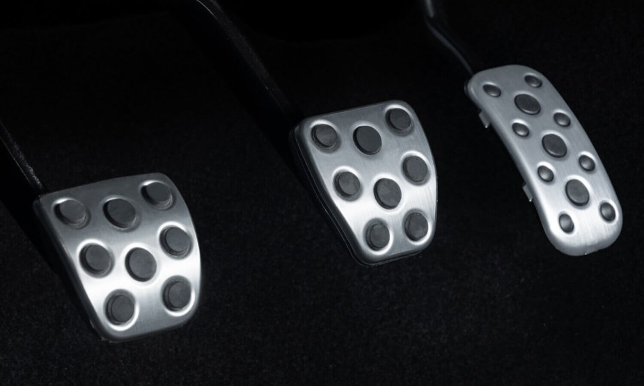 Detail shot of the three pedals (clutch, brake, and accelerator) in a Toyota Tacoma pickup truck.