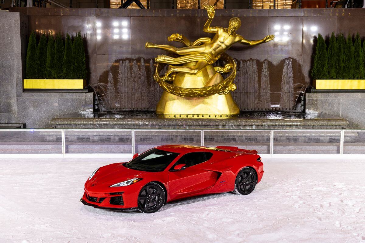 A 2024 Chevy Corvette E-Ray hybrid coupe model in Torch Red at Rockefeller Center