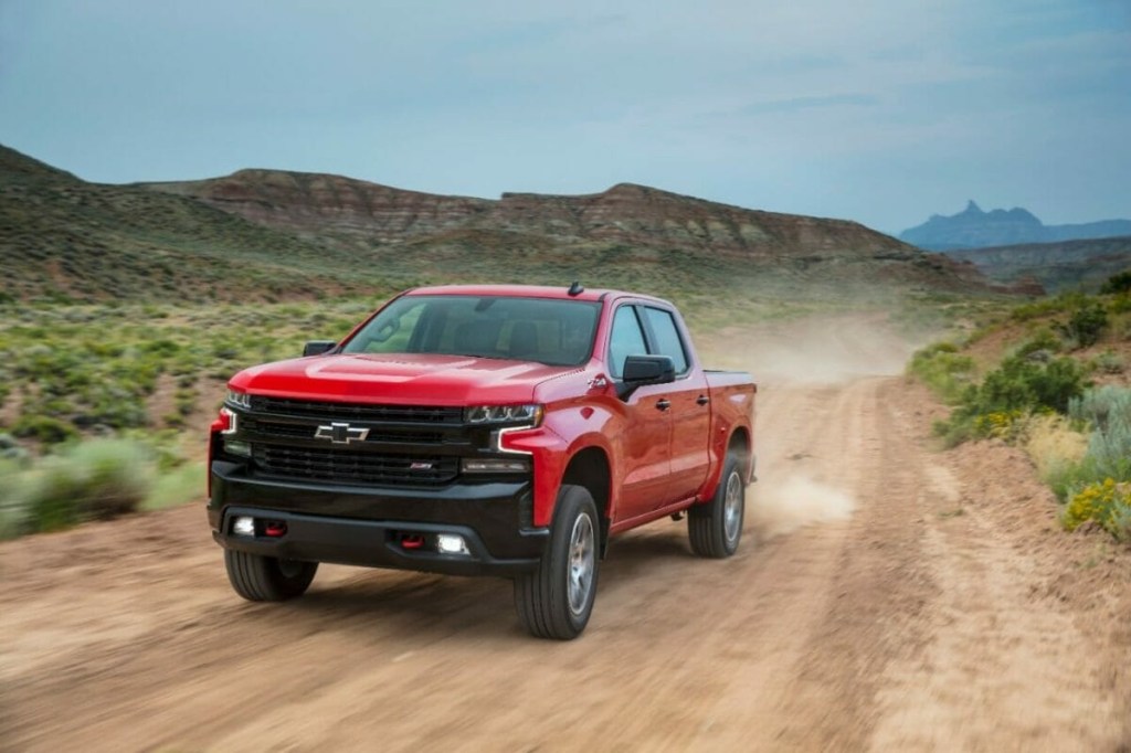 The 2024 Chevy Silverado driving on a dirt road 