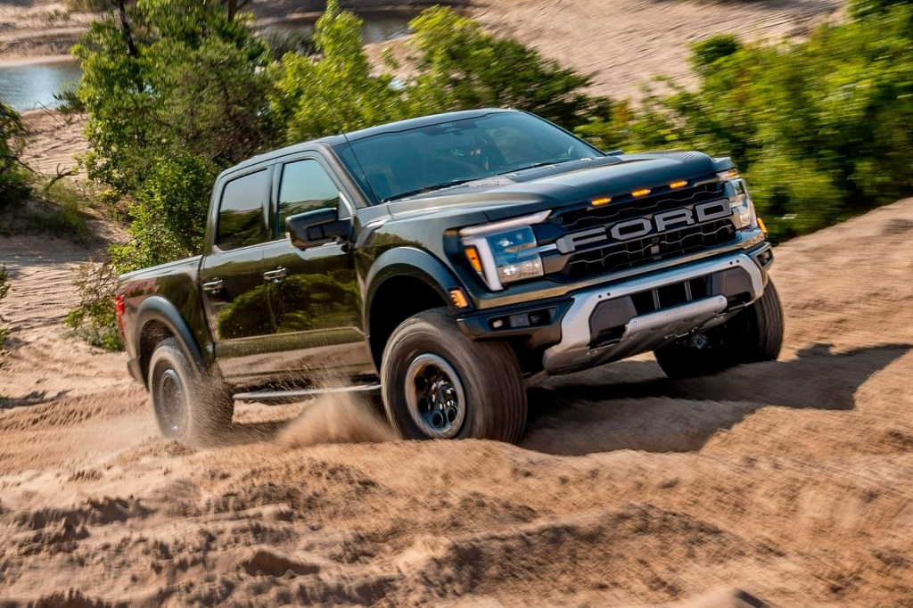 The 2024 Ford F-150 Raptor off-roading in mud