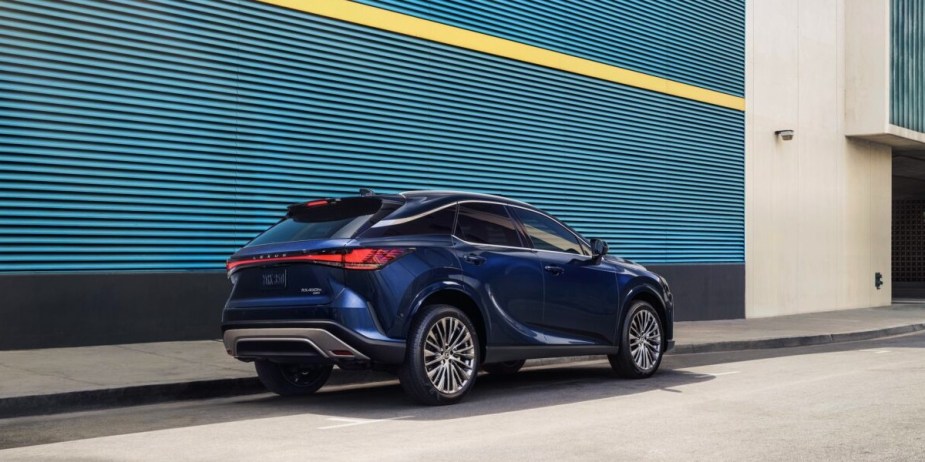 A blue 2024 Lexus RX450h+ small plug-in hybrid SUV is parked. 